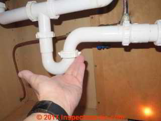 Checking the PVC sink trap connections for leaks after a repair (C) Daniel Friedman InspectApedia.com