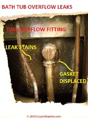 Bath tub overflow leaks into wall and ceiling (C) Daniel Friedman at InspectApedia.com