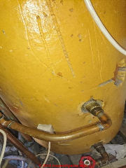 Foam insulation on a hot water cylinder in the U.K. (C) InspectApedia.com Barney 