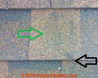 Green & black algae stains on a brown asphalt roof shingle (C) InspectApedia.com
