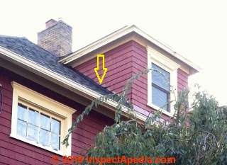 Roof dormer flashing snafu "fixed" with roof cement (C) InspectApedia.com NC