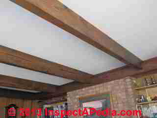 Original flat ceiling is retained with a roof-structure-over roof conversion from flat to pitched slope (C) InspectApedia