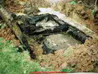 Photograph of a collapsing, impacted, failed home made septic tank.
