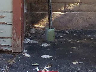 Sewage contamination in public area of a parking lot needs cleanup (C) InspectApedia.com Anne Gauvin