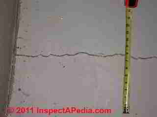 Concrete slab crack © Daniel Friedman at InspectApedia.com