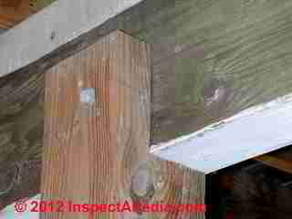 Notched post to beam connection at a deck © D Friedman at InspectApedia.com 