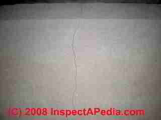 Vertical crack in a parged stuccoed concrete block wall (C) D Friedman B Maltempo