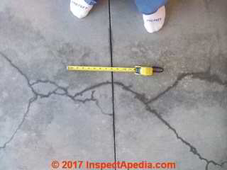 Severe cracks in new concrete garage floor slab (C) InspectApedia BH