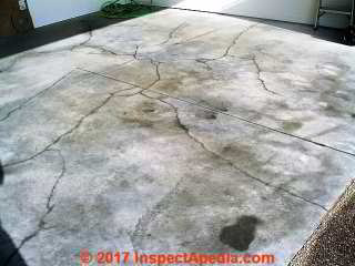 Severe cracks in new concrete garage floor slab (C) InspectApedia BH