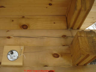 Cosmetic checing cracks in a milled log home (C) Inspectapedia.com Arlene Puentes