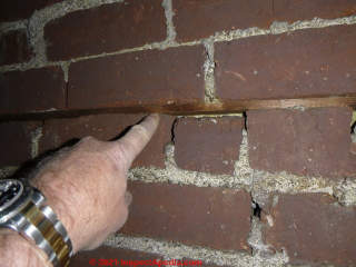 Wood strip nailer inserted into brick wall mortar joint (C) InspectApedia.com TransueL
