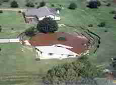 Photograph of a sink hole swallowing a house in Florida
